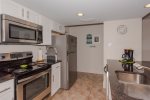 Fully equipped kitchen with dishwasher, microwave, and coffee maker